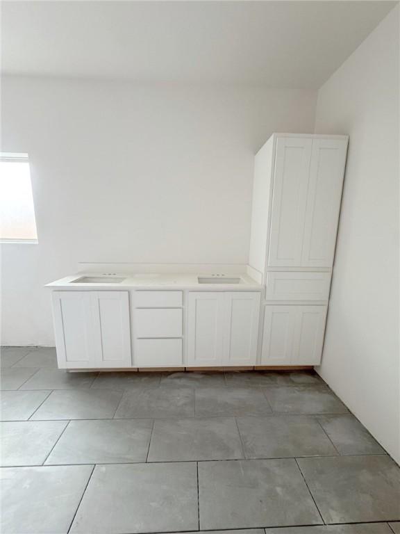 unfurnished bedroom with unfinished concrete flooring