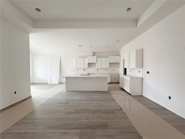 unfurnished living room with a raised ceiling