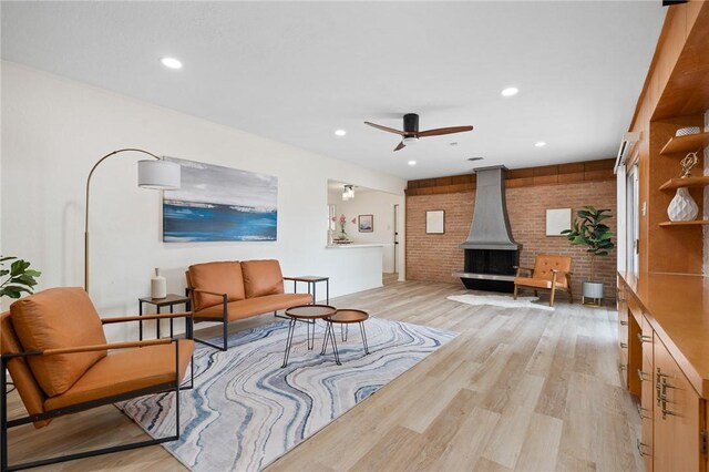 502 Meadowbrook Dr, Corpus Christi, TX 78412 - living room with light wood-type flooring, a wood stove, a ceiling fan, recessed lighting, and brick wall