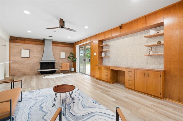 502 Meadowbrook Dr, Corpus Christi, TX 78412 - living area featuring light wood finished floors, a wood stove, a ceiling fan, built in study area, and recessed lighting