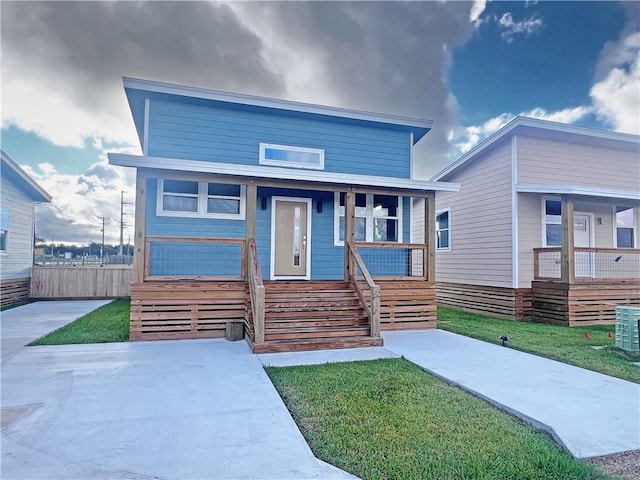 view of front of property with covered porch and a front yard