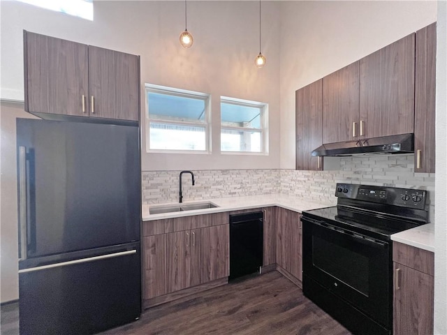 kitchen with dark hardwood / wood-style flooring, decorative backsplash, sink, and black appliances