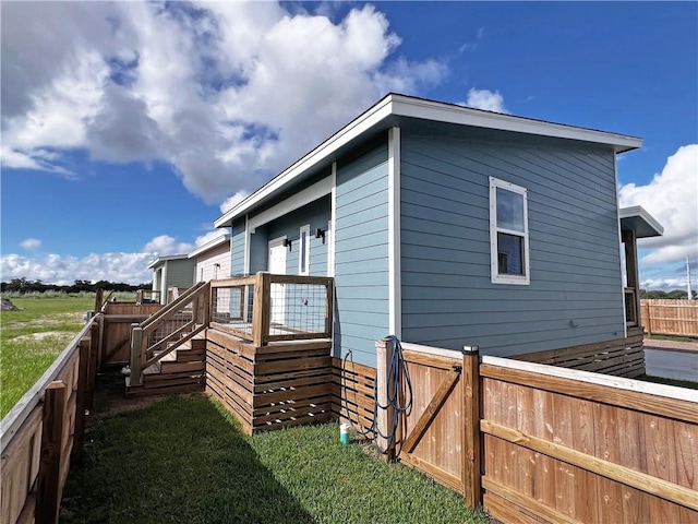 view of side of home featuring a lawn