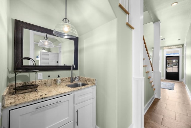 bathroom with tile patterned flooring, vanity, and baseboards