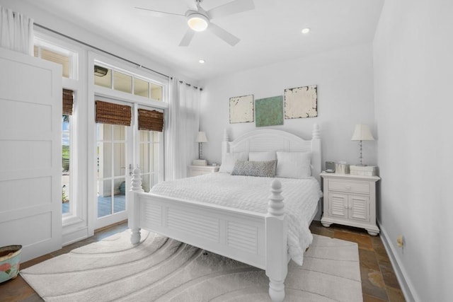 bedroom featuring ceiling fan, stone tile floors, recessed lighting, baseboards, and access to exterior