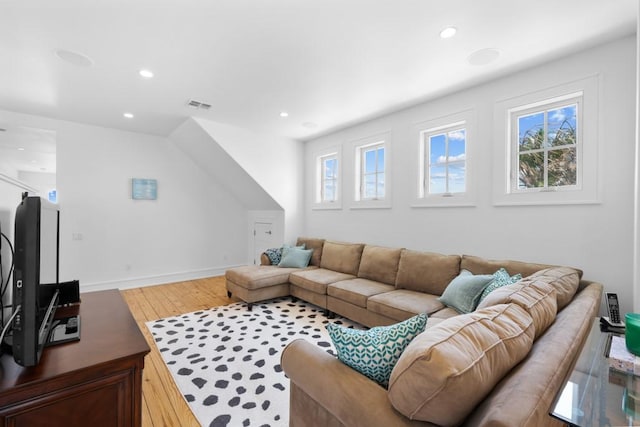 living area featuring recessed lighting, visible vents, baseboards, and wood finished floors