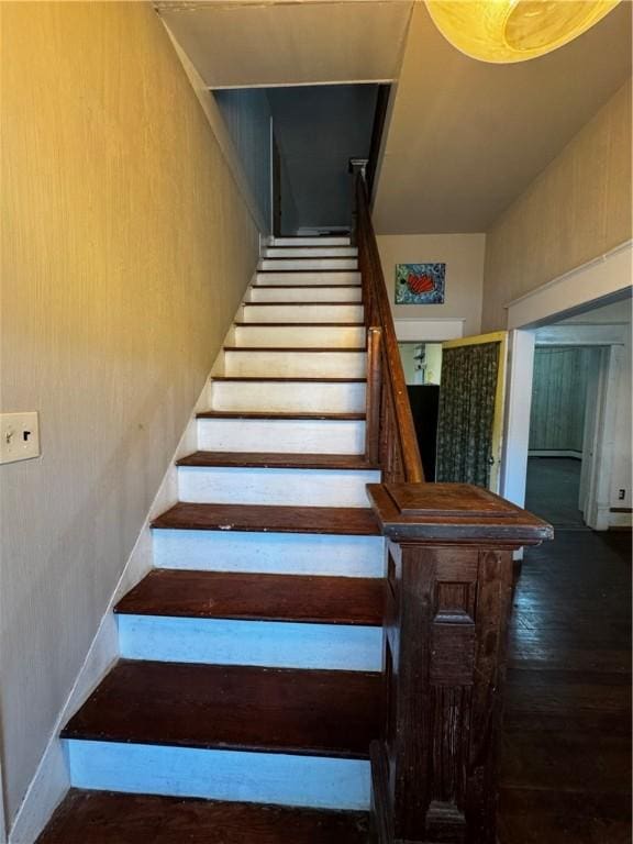 staircase featuring wood-type flooring