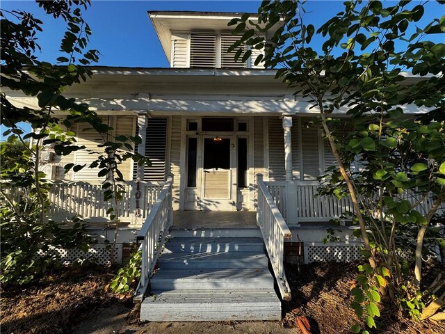 view of exterior entry featuring a porch