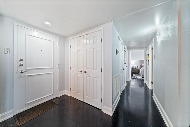 foyer with recessed lighting and baseboards