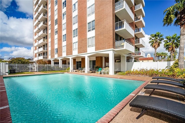 community pool with fence and central air condition unit