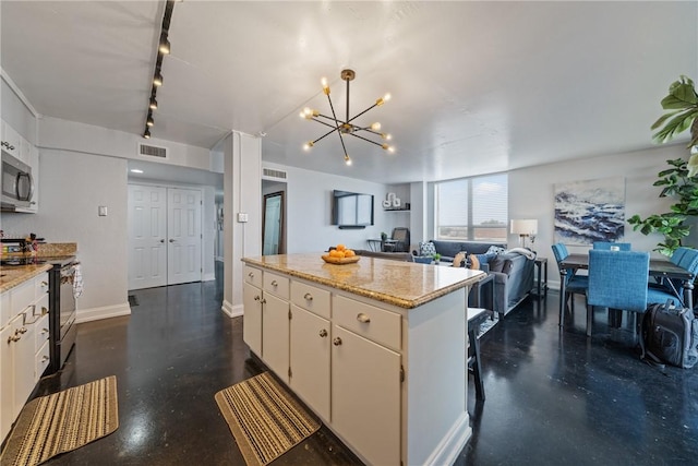 kitchen with visible vents, a kitchen island, electric range oven, stainless steel microwave, and rail lighting