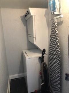 laundry room with laundry area and stacked washer / dryer
