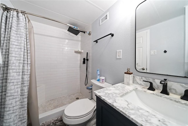 full bath with vanity, toilet, visible vents, and a stall shower