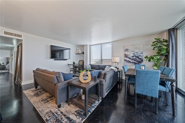 living area with visible vents and baseboards