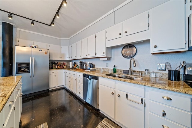 kitchen with rail lighting, a sink, light stone counters, white cabinets, and stainless steel appliances