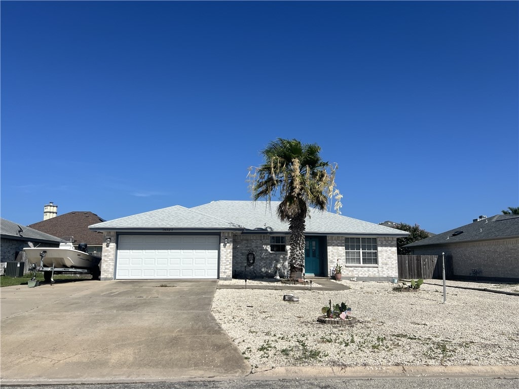 14322 Scallop St, Corpus Christi, TX 78418 - ranch-style home with concrete driveway, a garage, and brick siding