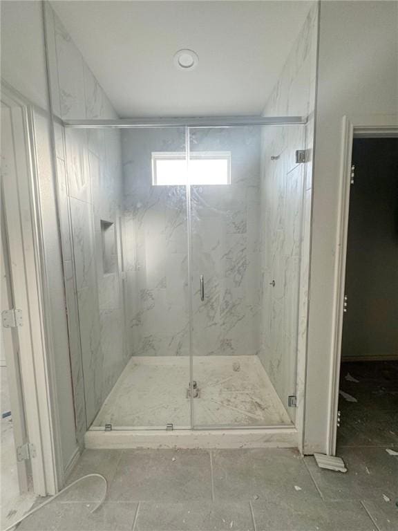 bathroom with a shower with shower door