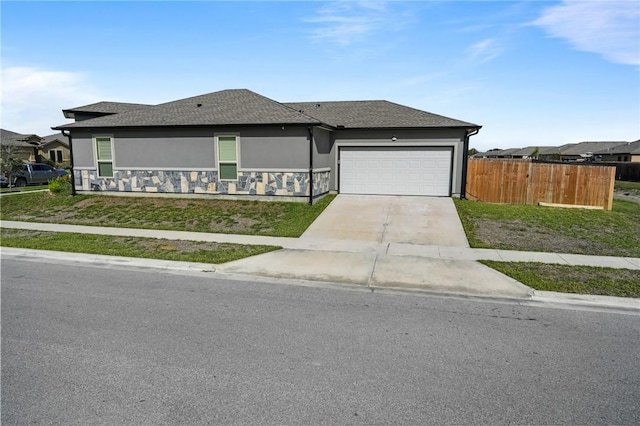 view of front of home with a front yard and a garage