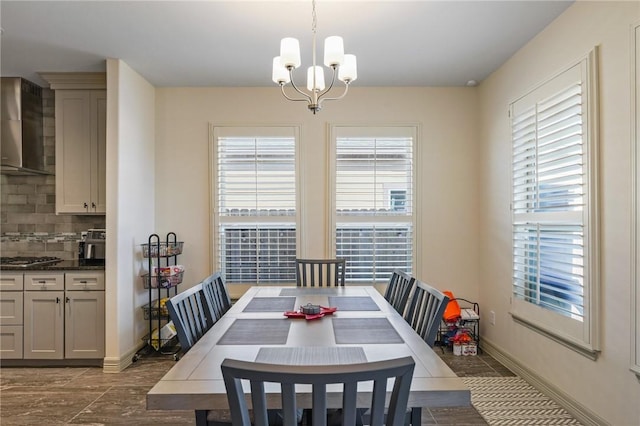 tiled dining room featuring an inviting chandelier