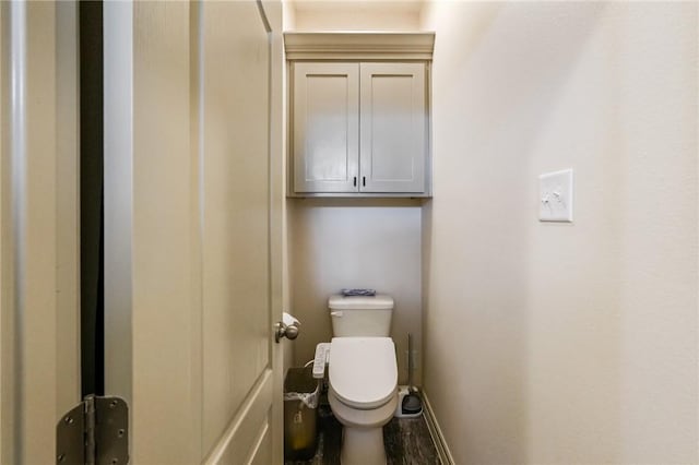 bathroom featuring hardwood / wood-style flooring and toilet