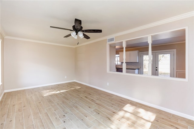 empty room featuring ceiling fan, french doors, ornamental molding, and light hardwood / wood-style flooring