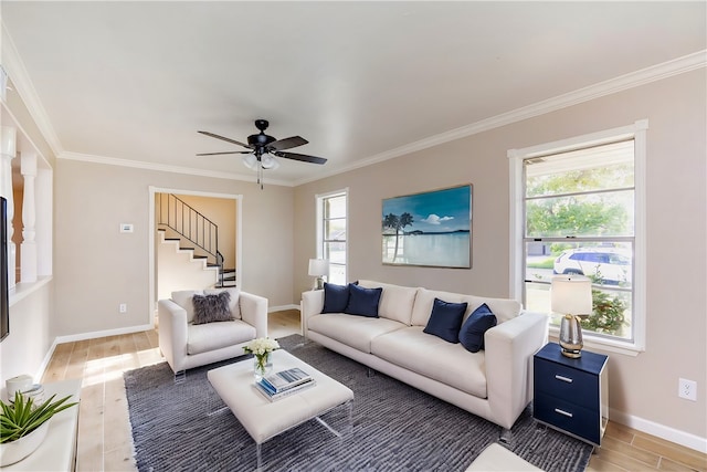 living room with a wealth of natural light, wood-type flooring, and ornamental molding