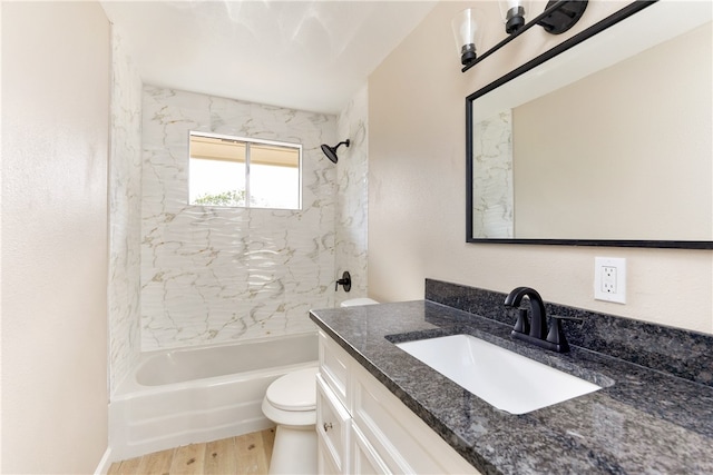 full bathroom with wood-type flooring, tiled shower / bath combo, toilet, and vanity