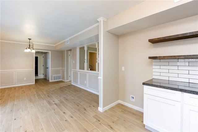 interior space featuring a chandelier, crown molding, and light hardwood / wood-style flooring