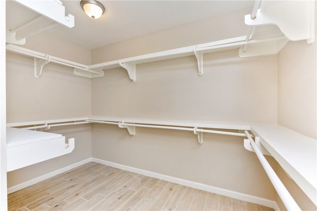 spacious closet featuring light wood-type flooring