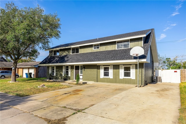 view of front of home featuring central AC unit and a front lawn