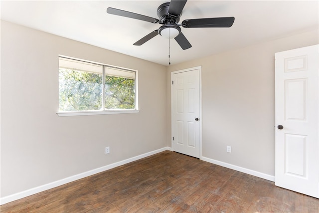 unfurnished room with ceiling fan and dark hardwood / wood-style floors