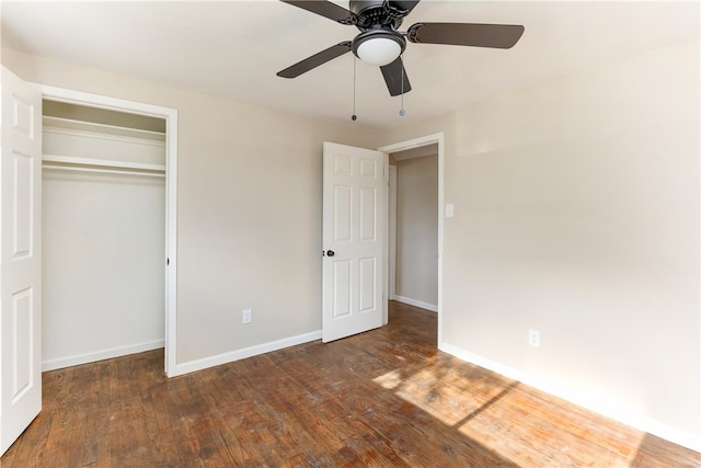 unfurnished bedroom featuring dark hardwood / wood-style flooring, a closet, and ceiling fan