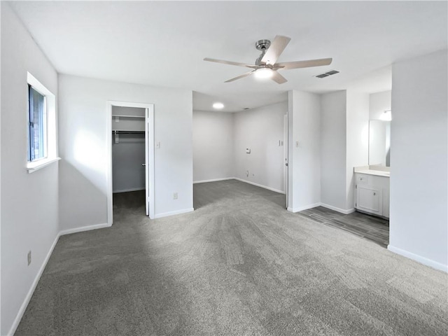 3658 Braeburn Dr, Corpus Christi, TX 78415 - unfurnished bedroom featuring visible vents, ceiling fan, carpet flooring, a walk in closet, and baseboards