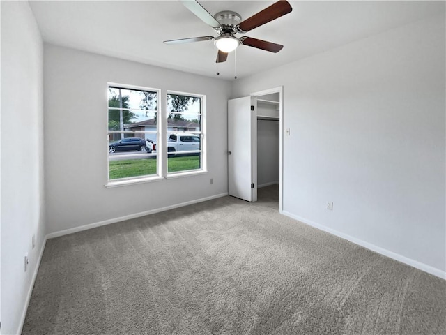 3658 Braeburn Dr, Corpus Christi, TX 78415 - unfurnished bedroom with carpet floors, a ceiling fan, baseboards, and a walk in closet