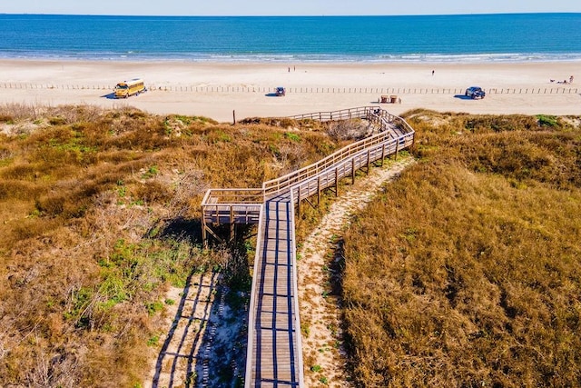 birds eye view of property with a water view and a view of the beach