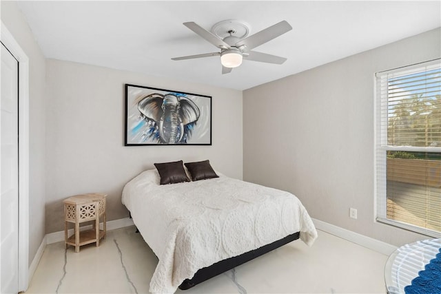 bedroom with baseboards and a ceiling fan