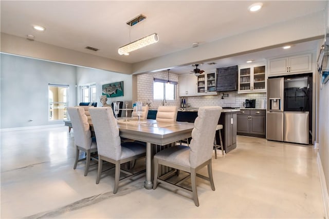 dining room featuring baseboards, visible vents, ceiling fan, concrete floors, and recessed lighting