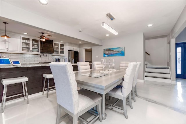 dining space with baseboards, a ceiling fan, stairway, concrete floors, and recessed lighting