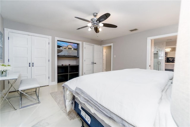 bedroom featuring two closets, concrete floors, visible vents, and a ceiling fan