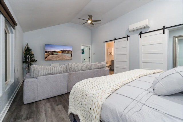 bedroom featuring vaulted ceiling, a barn door, a wall mounted AC, and wood finished floors