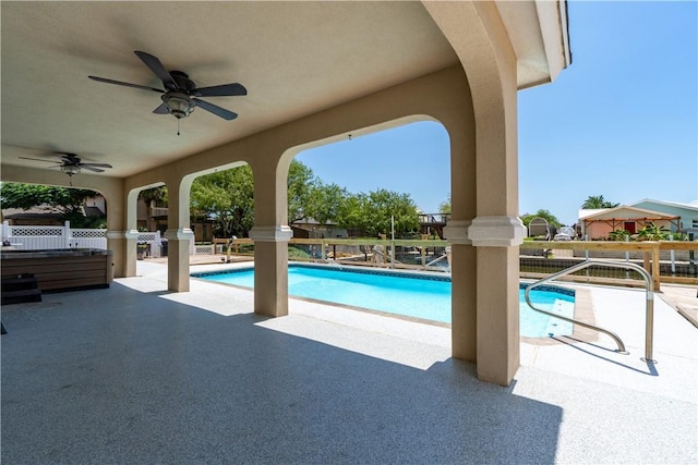 view of swimming pool featuring ceiling fan, a patio area, fence, and a fenced in pool