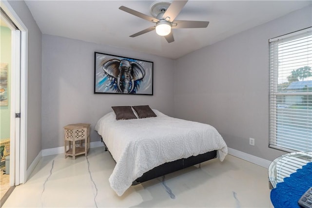 bedroom with ceiling fan, finished concrete flooring, and baseboards