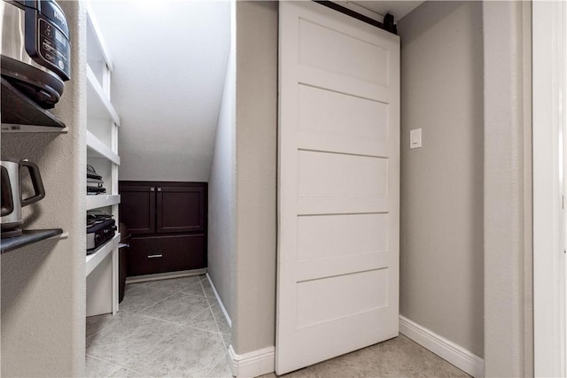 walk in closet with light tile patterned floors