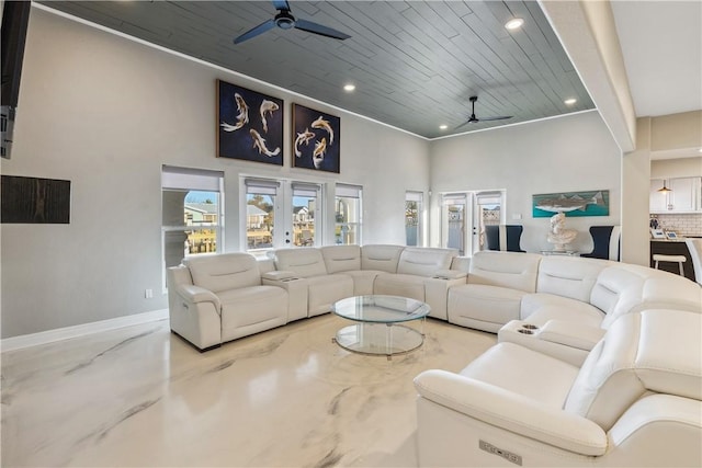 living area with baseboards, recessed lighting, a high ceiling, a ceiling fan, and wooden ceiling