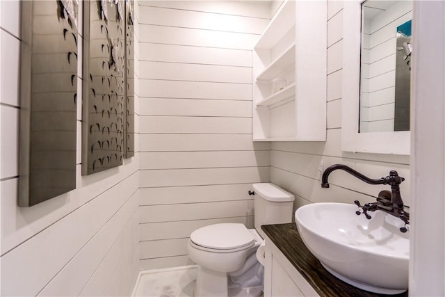 bathroom featuring toilet and vanity