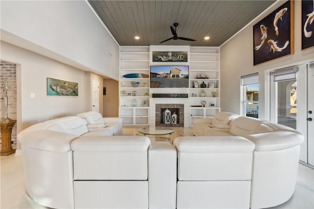 living room with built in features, wooden ceiling, a brick fireplace, ceiling fan, and recessed lighting