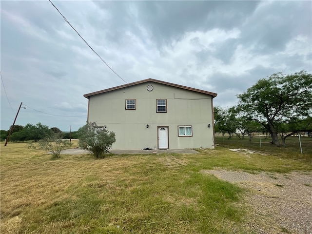 back of property featuring a lawn