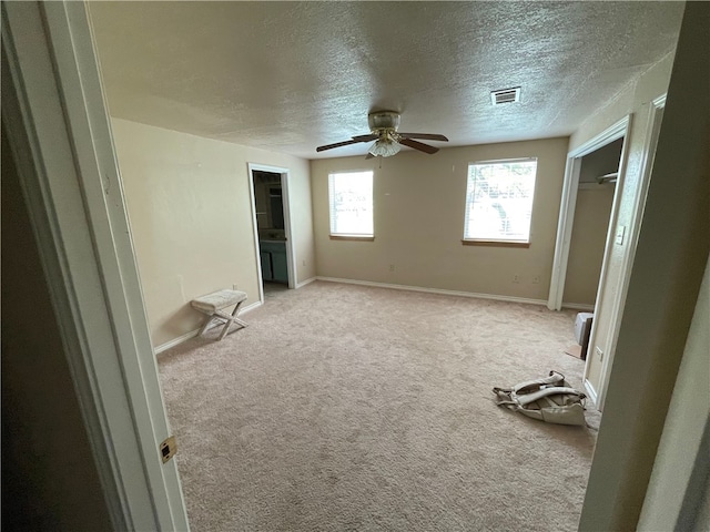 unfurnished bedroom featuring a closet, light carpet, and ceiling fan