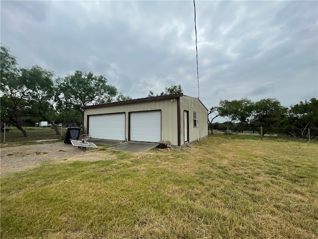 garage featuring a lawn