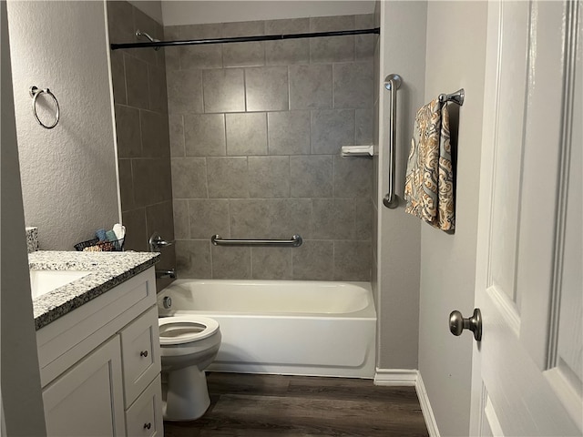 full bathroom featuring toilet, vanity, hardwood / wood-style floors, and tiled shower / bath